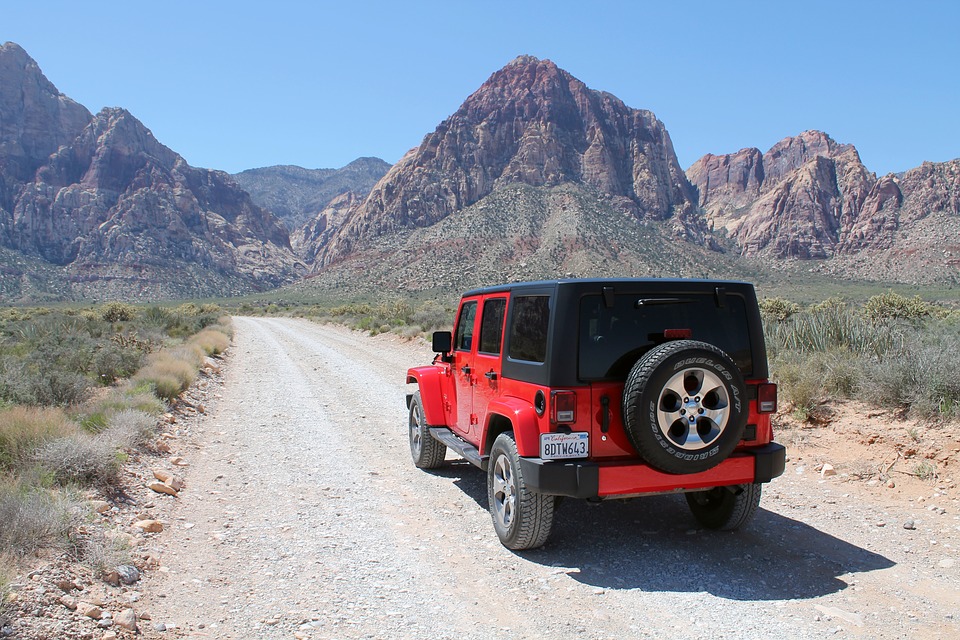 Red four-wheel-drive travelling to the hidden Palm Valley